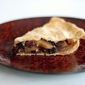 close up slice of Winter Fruit Pie in a red plate