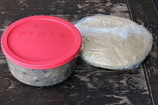 Bean, Potato and Sausage Soup in a plastic container ready to be move in frezer