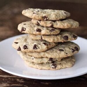 Close up Stack of Dairy Free Oatmeal Chocolate Chip Cookie in small white plate on wood background