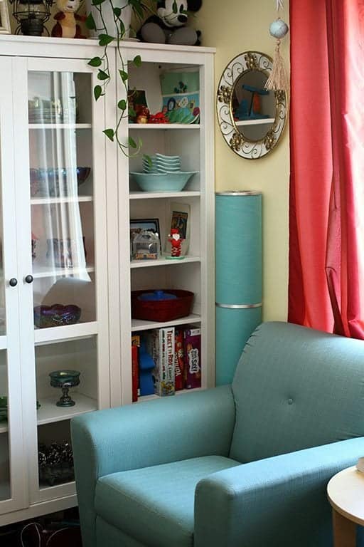 couch with retro color and white shelving with books and glasswares