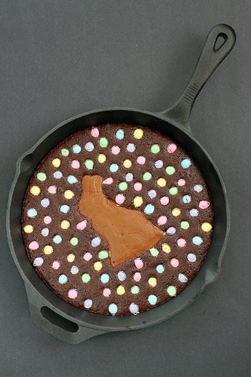 top down shot of Skillet Brownie with a chocolate bunny smack dab in the middle, surrounded by colored M&M's