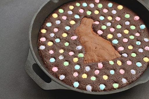 Skillet Brownie with a chocolate bunny smack dab in the middle, surrounded by colored M&M's