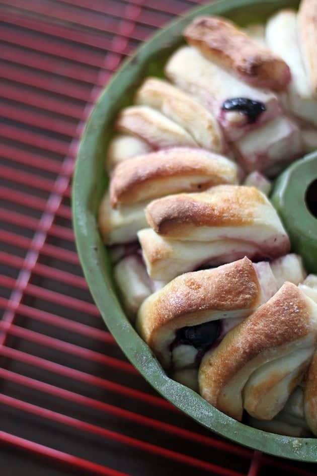 close up of the pull apart loaf in bundt pan on red cooling rack