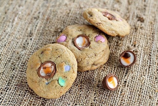 Three pieces leftover Easter Candy Cookies in fiber cloth background