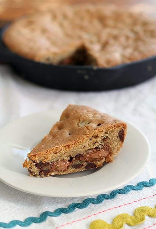 close up of Mars Bar Stuffed Skillet Chocolate Chip Cookie in a White Plate