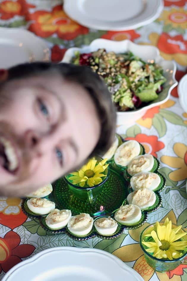 classic deviled eggs in green egg plate, blur picture of a man in photo