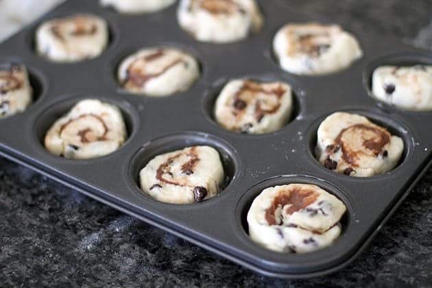 well greased muffin tin with chocolate cream cheese dough