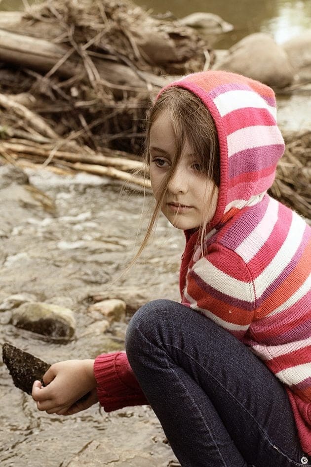 close up of young girl holding a stone