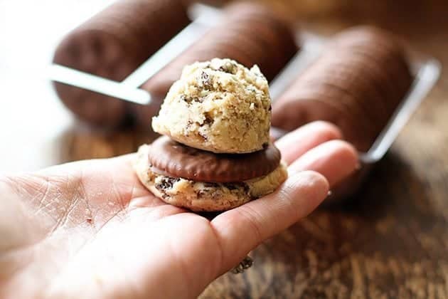 two cookie dough with chocolate coated cracker in between