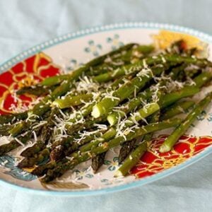 Close up of Roasted Garlic Asparagus With Sorvrano Cheese on Top