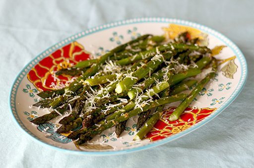 Close up of Roasted Garlic Asparagus With Sorvrano Cheese on Top