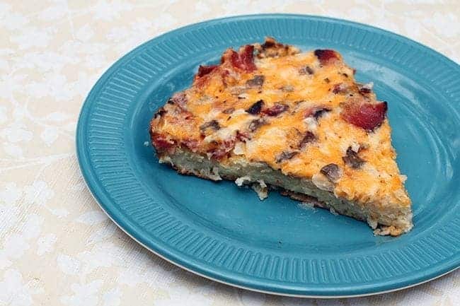 s slice of breakfast pizza in a blue plate