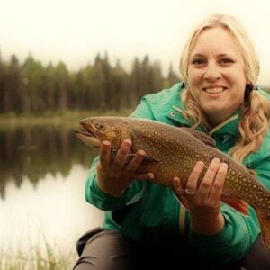 woman holding a freshly caught brook trout