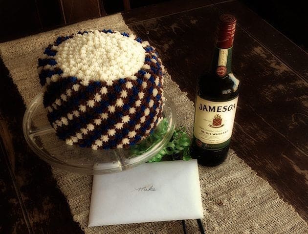 Simple Father's Day Cake with blue, white and brown star icing, a bottle of whisky beside it