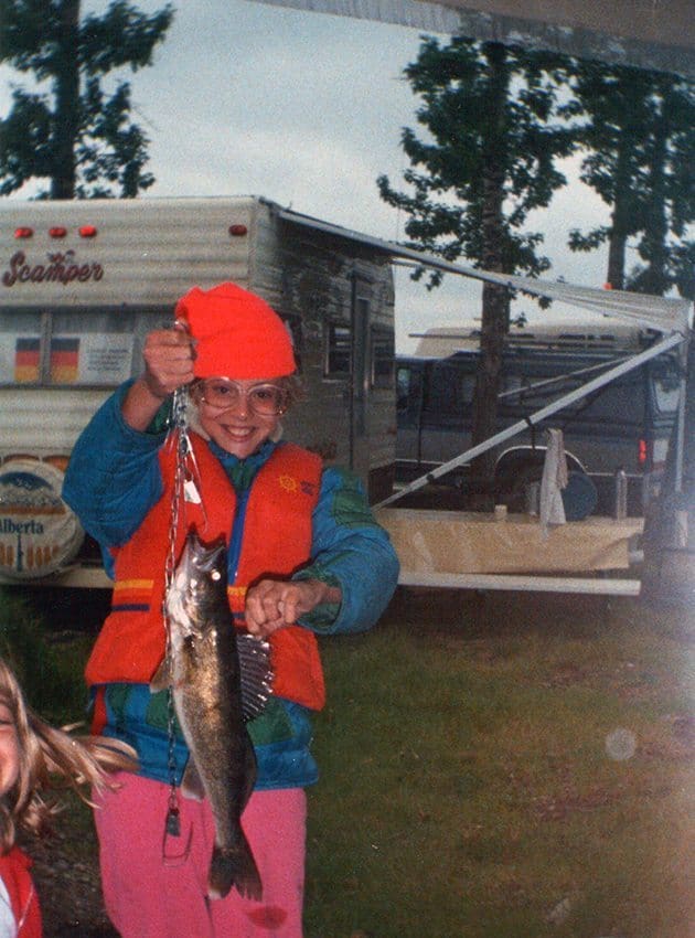 little girl holding a chain with walleye in it