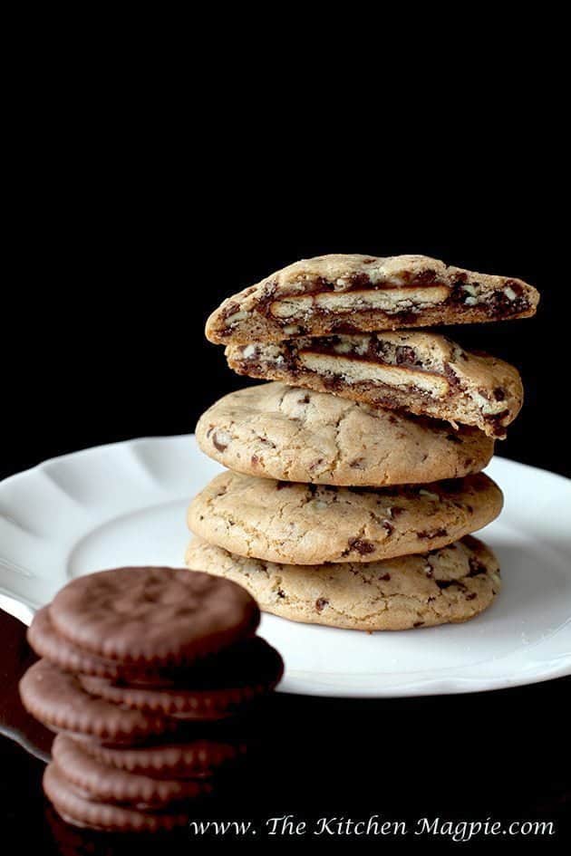 Close up of Ritz Stuffed Mint Chocolate Chip Cookie in White Plate and chocolate coated crackers in front