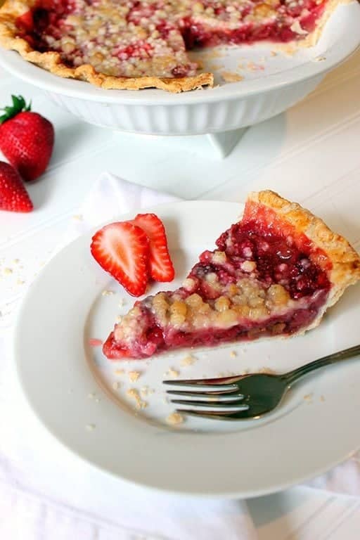 sliced classic Rhubarb Strawberry Pie and fresh strawberries