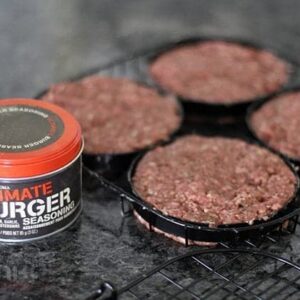 a can of Ultimate Burger Spice and burger patties in william's sonoma hamburger grilling basket