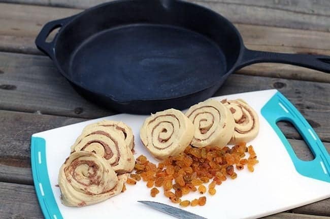 ingredients in making monkey bread in a white chopping board and a skillet beside it