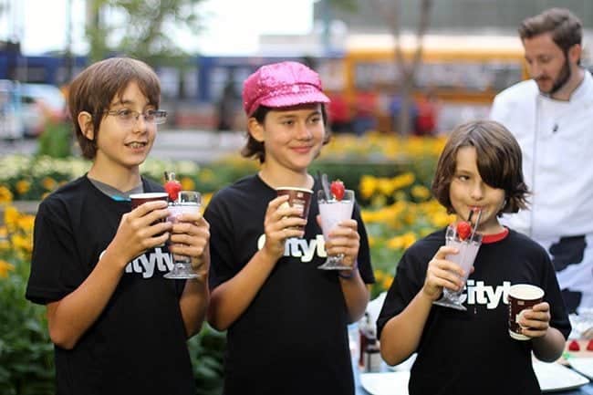 three young kids enjoying the smoothies