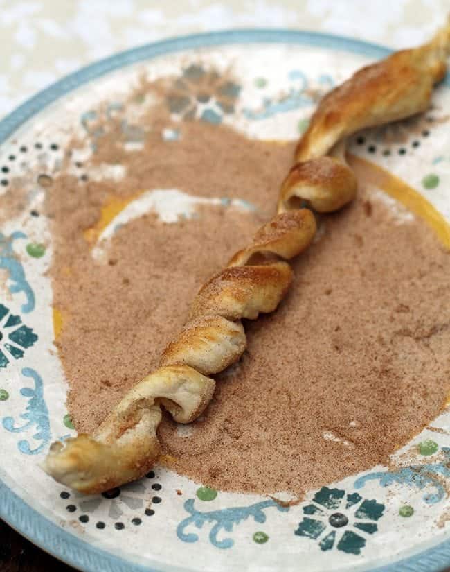 cooked swirl dough brushed with butter and rolled in cinnamon sugar