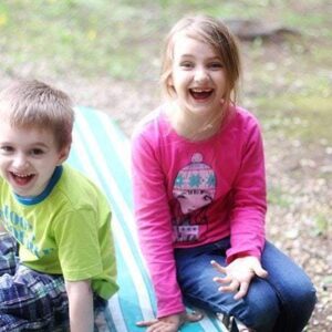 little boy and girl sitting and making goofy face