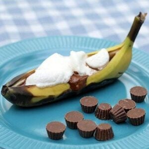 Close up of Reese's Peanut Butter Cup Banana Boat in blue plate