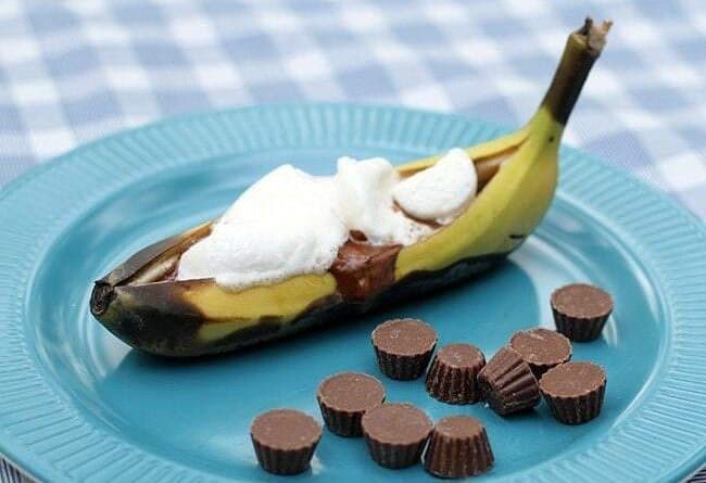 Close up of Reese's Peanut Butter Cup Banana Boat in blue plate