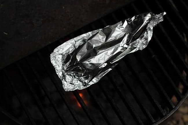 Aluminum wrapped banana boat placed on the firepit grill