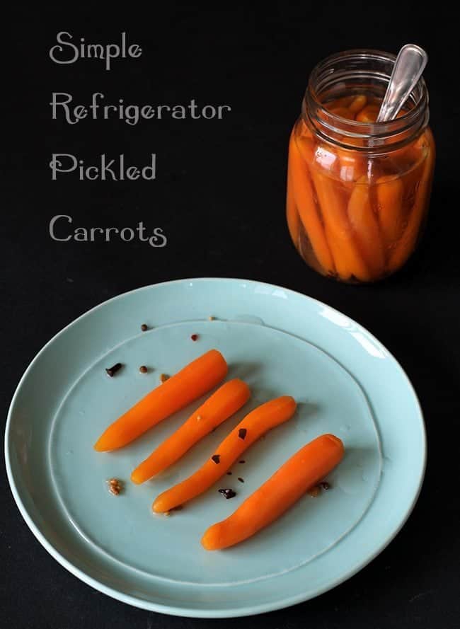 Pickled Carrots on a blue plate and in canning jar on black background