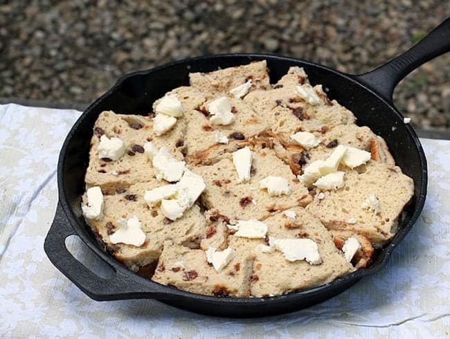 raisin breads in skillet topped with diced butter