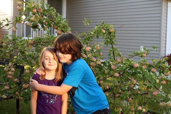 older brother hugs his younger sister