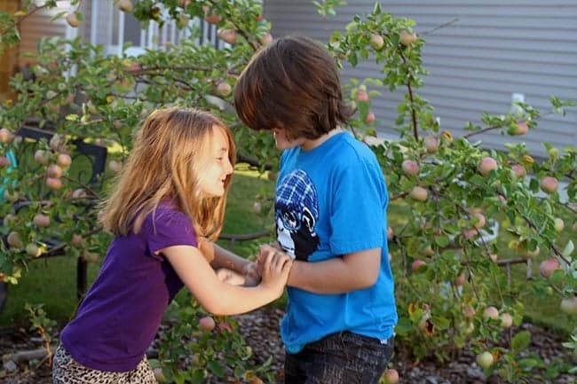 little sister shoving her big brother around