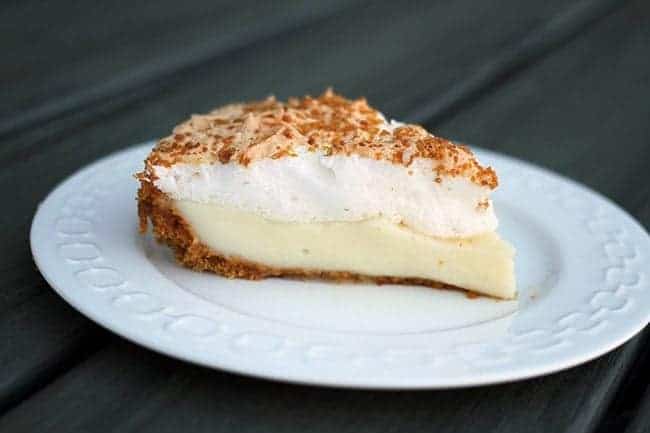 A slice of Flapper Pie in a White Plate with cinnamon laced graham crumbs on top