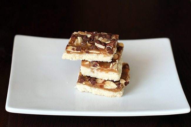 Three Pieces of Almond Crunch Toffee Bars in a White Plate