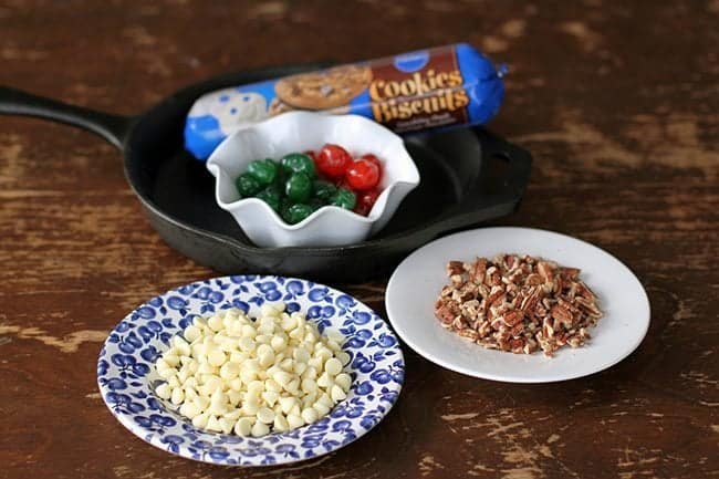 Four ingredients for Chocolate Chip Skillet Cookie in a wood background