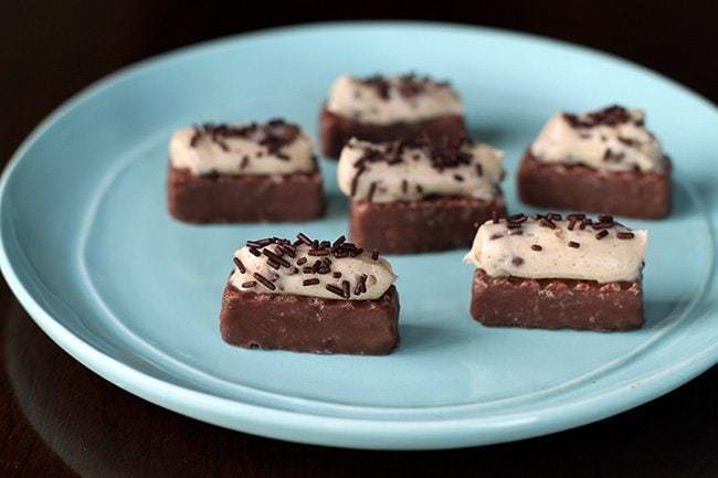 close up of Cheesecake Bites with Chocolate Sprinkles on Top in a Blue Plate