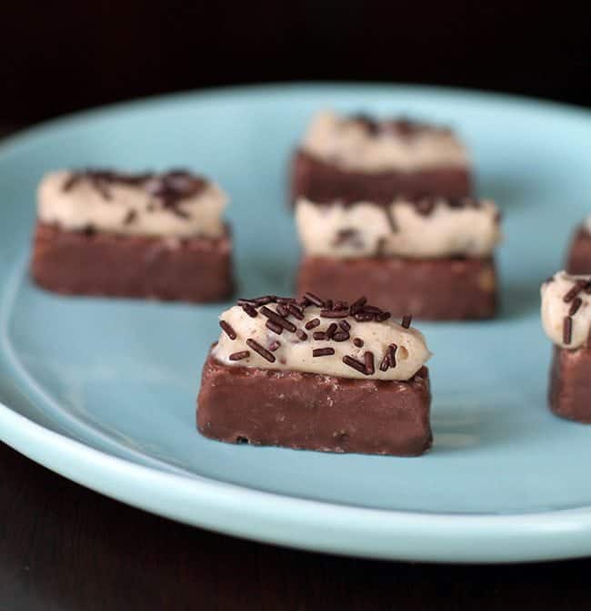 close up of Cheesecake Bites with Chocolate Sprinkles on Top in a Blue Plate