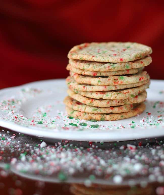 Close up Stack of Buttery Candy Cane Cookies in a White Plate with Crushed Candy Cane