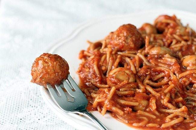 Crock Pot Spaghetti & Meatballs in white Plate on White tablecloth