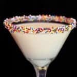 close up Eggnog Martini with colorful sprinkles on the rim