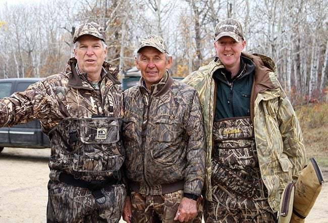 three men wearing duck hunting gears