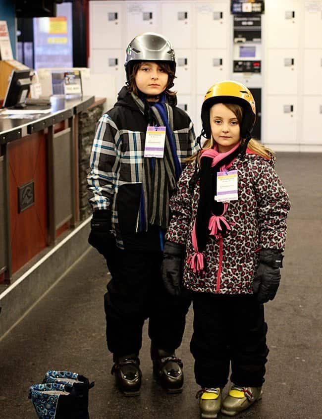 kids with poker faces wearing their skiing gears