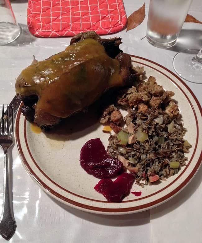 close up of Braised Wild Duck with dressing in a plate together with homemade pickled beets