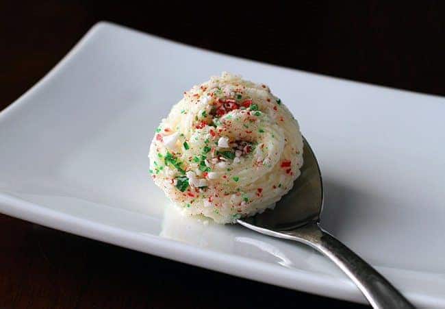 a spoon of Peppermint Buttercream Frosting in a white plate