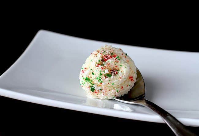 a spoon of Peppermint Buttercream Frosting in a white plate