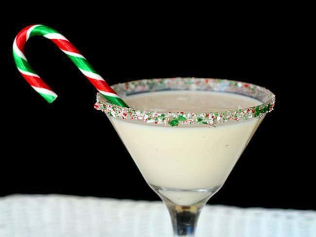 Peppermint eggnog martini with a glass rim covered with candy crane