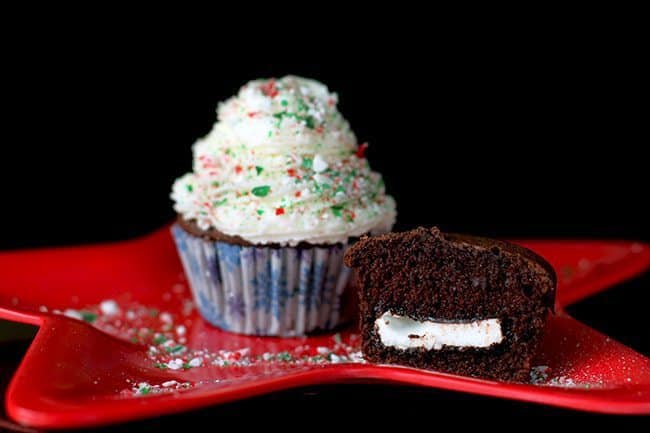 Chocolate Cupcake with Peppermint Buttercream Icing on Top, another half cupcake showing the inside stuff