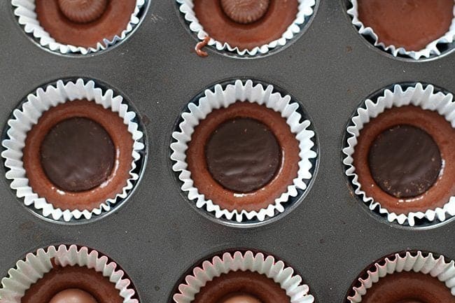 cupcake liner with two-thirds full, a patty on top and covered with batter