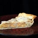 a slice of Scalloped Onion Pie in a red plate